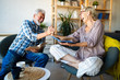 © NDABCREATIVITY - Beautiful old couple is reading a book and smiling at home