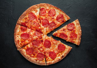 Wall Mural - Pepperoni pizza on stone background, ready to eat