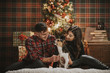 © Broadway - Young couple celebrating Christmas together with the Dog