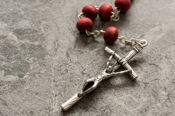 Wall Mural - Rosary on the stone background close-up view