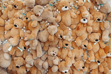 Decoration wall of many beige teddy bears.