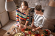 © BalanceFormCreative - Two female friends  preparing vegetarian meal.They making fun a the kitchen and preparing vegetables.