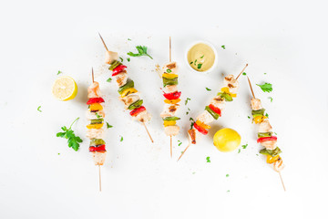 Homemade chicken meat skewers with vegetables, top view copy space