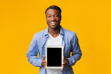 Wall Mural - African American Guy Showing Empty Tablet Screen Standing, Studio, Mockup