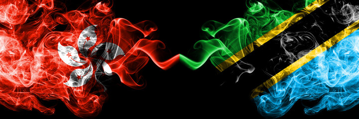 Hong Kong, China vs Tanzania, Tanzanian smoky mystic states flags placed side by side. Concept and idea thick colored silky abstract smoke flags