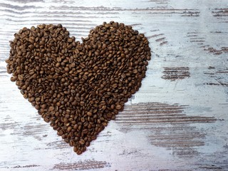  close-up of freshly roasted brown aromatic heart-shaped coffee beans