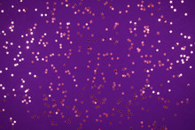 Little Gold Stars On Purple Background Festive Holiday Background. Celebration Concept. Top View,