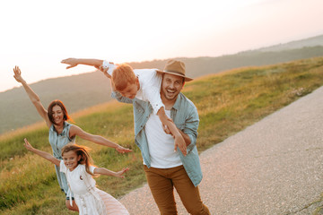 Happy smiling family spending summer day at park.