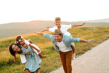 Happy smiling family spending summer day at park.Happy smiling family spending summer day at park.