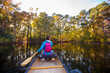 © Tandem Stock - Rear view of woman canoeing in pond