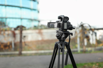 Professional video camera outdoors. Space for text