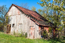 Abandonded Old Barn On A Hillside