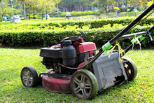 Old Red Lawn Mower On The Lawn