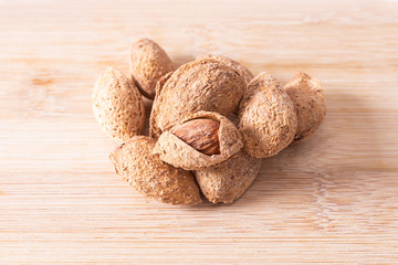 Wall Mural - almonds isolated on wooden background