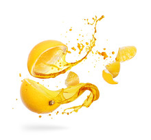 Juice Splashes Out From Sliced Orange On A White Background