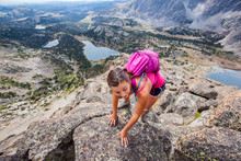 A Woman Tops Out On The Summit Of Pyramid Peak (12,030) In The WInd River Range During A Backpacking Trip In August. Pyramid Lake (right), Mae's Lake (center) And Skull Lake (left) Are Pictured In The Background.