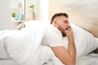 © Pixel-Shot - Morning of sleepy young man  in bed