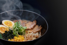Hot Delicious Japanese Ramen Noodles With Pork Egg Corn Scallions And Seaweed In Black Background. Copy Space.