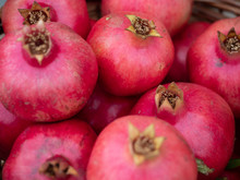 Multiple Ripe Pomegranates At An Outdoor Market