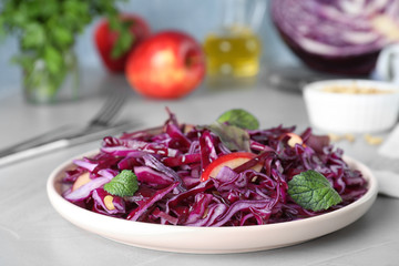 Fresh red cabbage salad served on light grey table