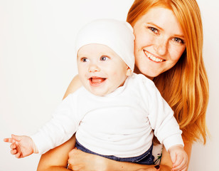 young beauty mother with cute baby toddler, red head happy modern family, lifestyle people concept