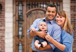 © Andy Dean - Happy Mixed Race Couple with Baby in Front of House