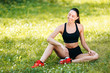 © speed300 - Girl in sportswear  sitting in the park outdoor. Concept relax