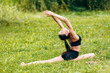 © speed300 - Yoga girl doing asana on the grass in the park outdoor with hands up. - Image
