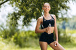 © speed300 - Portrait of sporty woman in sportswear standing  with a bottle water outdoors.- Image