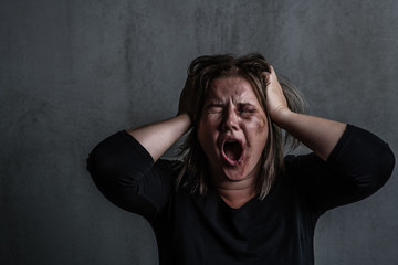 Wall Mural - Angry young woman victim of domestic violence and abuse having nervous breakdown screaming. Empty space for text