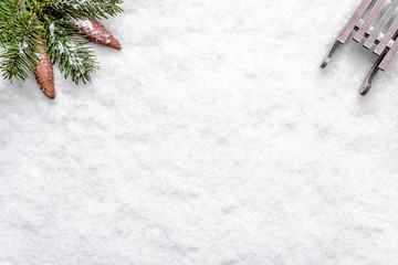 Wall Mural - Christmas background with snow, sleigh, and christmas pine branch, composition flat lay, top view