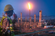 Engineer with safety helmet with oil refinery industry plant background