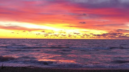 Wall Mural - Dramatic twilight sky over Lake with cold waves dashing upon the shore.