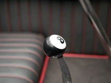 The Shift Lever Of An Automatic Transmission Of A Vehicle With Installed Black Pool Ball As A Handle. Figure 8 On White Background
