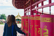 © Александр Коновалов - two girls traditionally spin Buddhist prayer drums around the temple in a holy place on a clear sunny day