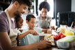 © NDABCREATIVITY - Happy family in the kitchen having fun and cooking together. Healthy food at home.