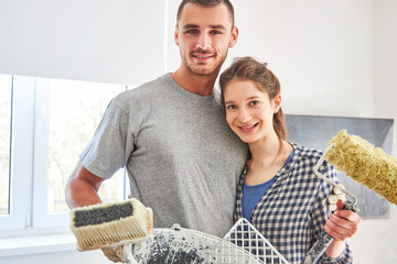 Wall Mural - Handyman couple with paint roller and paste brush