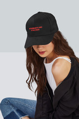 Wall Mural - Cropped upward shot of a dark-haired girl, wearing black baseball cap with lettering 