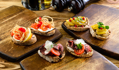 Wall Mural - Traditional italian bruschetta on wooden cutting board. Close up view