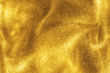 Fototapeta  - Abstract elegant, detailed gold glitter particles flow with shallow depth of field underwater. Holiday magic shimmering luxury background. Festive sparkles and lights. de-focused.