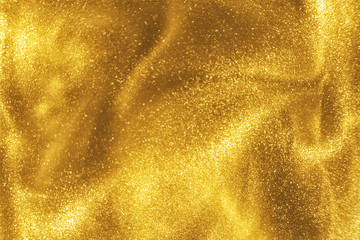 abstract elegant, detailed gold glitter particles flow with shallow depth of field underwater. holid