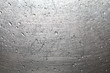 Drops of water on a scratched metal background closeup