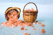 Himalayan Salt On Turquoise  Surface . Pink Spa . In A Basket . Salt On The Table In The Basket