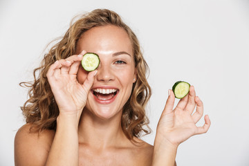 Poster - Image of happy half-naked woman smiling and pieces of cucumber