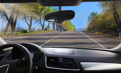 Wall Mural - highway towards the city lit by the spring sun