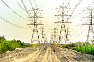 Wall Mural - installation of a new electricity supply poles without it's cables in the middle of desert in Saudi Arabia  