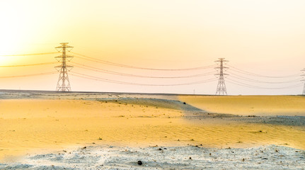 Wall Mural - installation of a new electricity supply poles without it's cables in the middle of desert in Saudi Arabia  