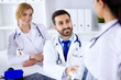 © khmelev - Young smiling arab doctor shakes hands with a nurse in a hospital. Interracial Group of young doctors in the office