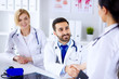 © khmelev - Doctors in the office communicate and shake hands.