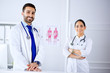 © khmelev - Two young smiling arab doctors standing in consultation room in hospital